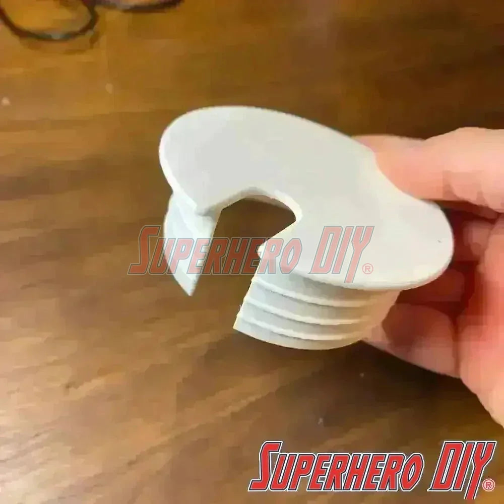 IKEA MICKE desk hole cover in white, held in hand, designed to fit perfectly into the open wiring hole on IKEA MICKE desks.
