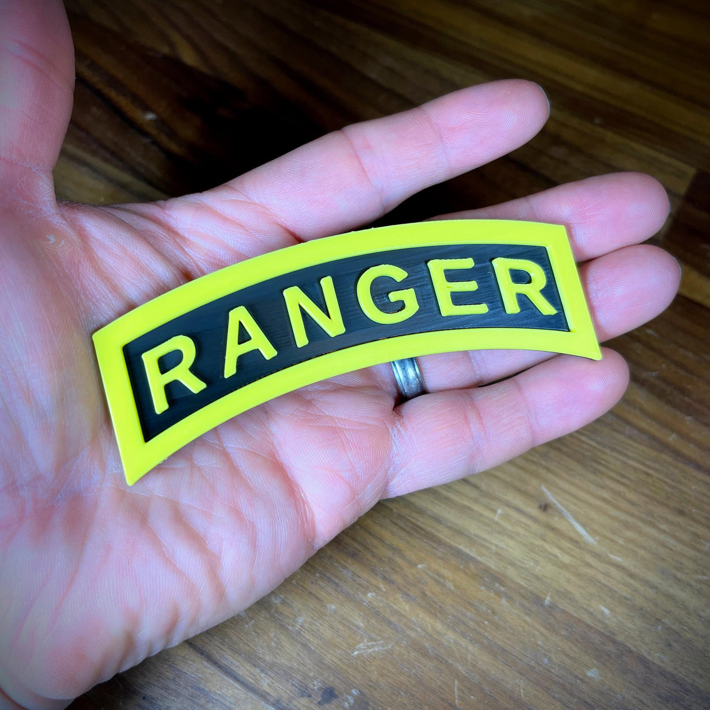 3D Army Ranger tab displayed in hand, featuring the iconic yellow and black design.