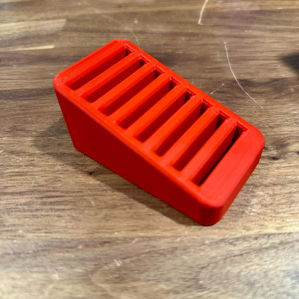 CFexpress Type B card organizer, 8-slot red desk holder for memory cards, stepped design for easy access, wooden background