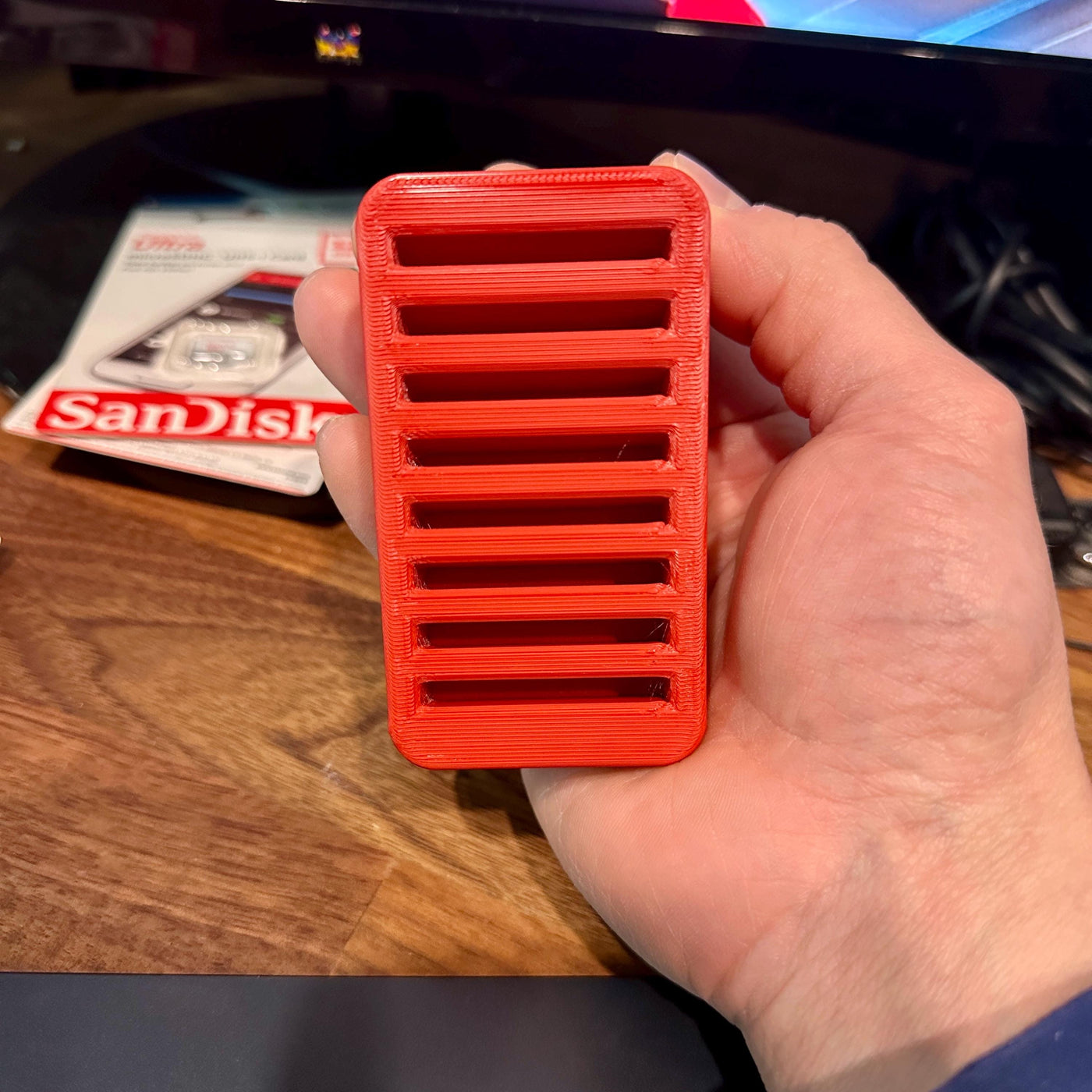 Person holding an 8-slot CFexpress Type B card organizer
