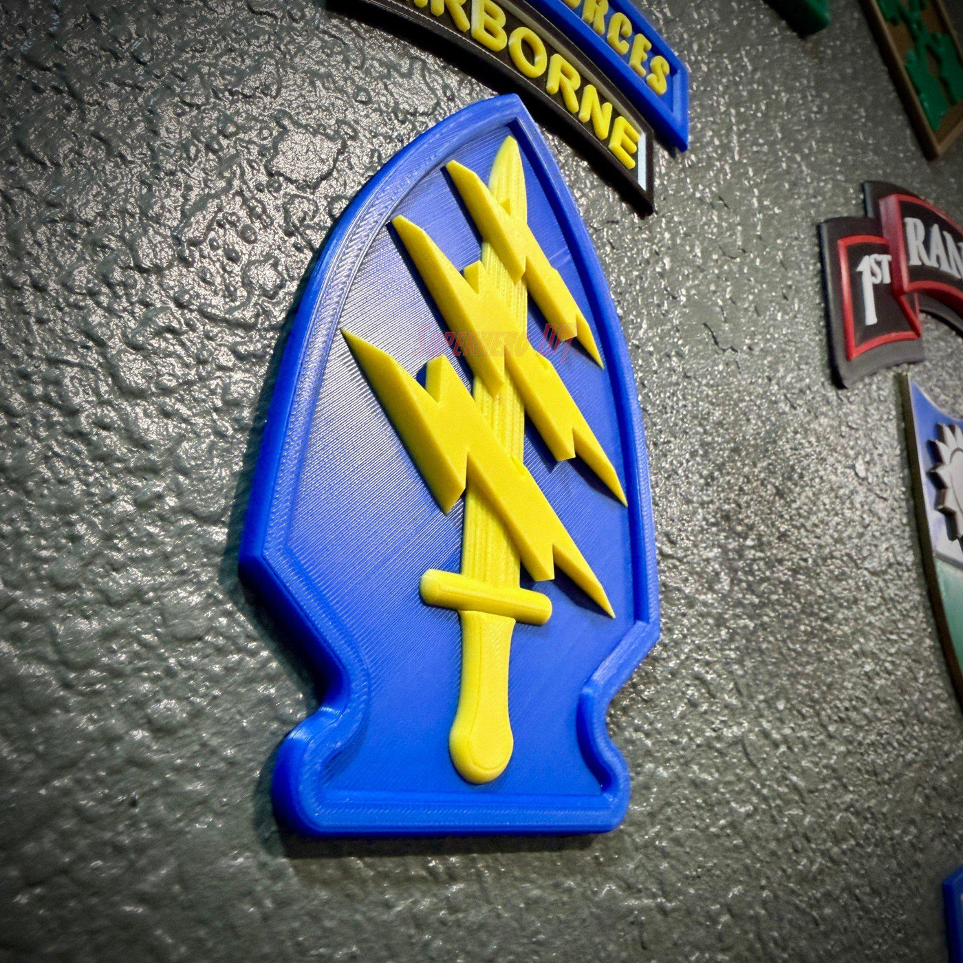 Special Forces display insignia featuring yellow dagger and lightning bolts on blue background.