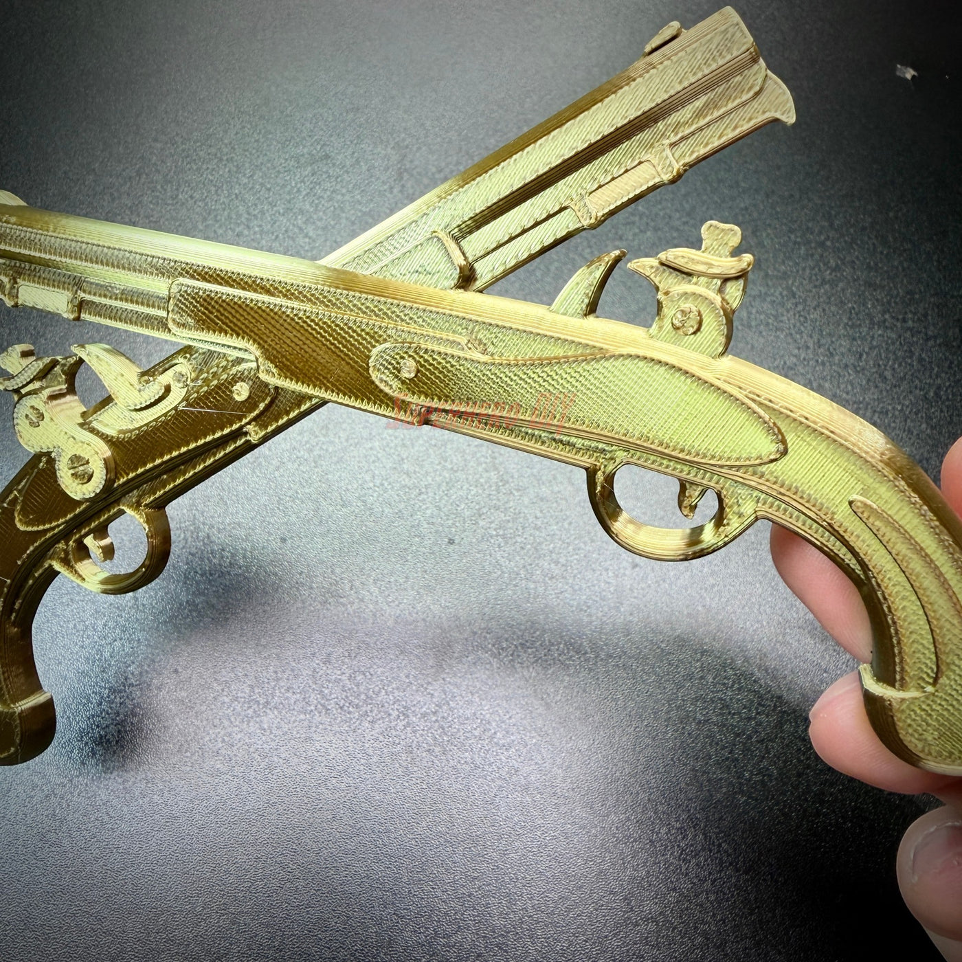 Army military police insignia crossed pistols wall display in gold finish against a dark background.