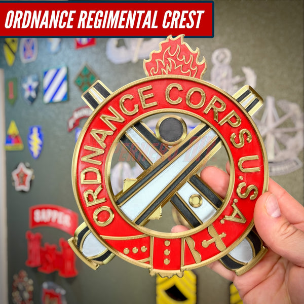 Ordnance Regimental Crest displayed in red and gold on a hand, showcasing military insignia.