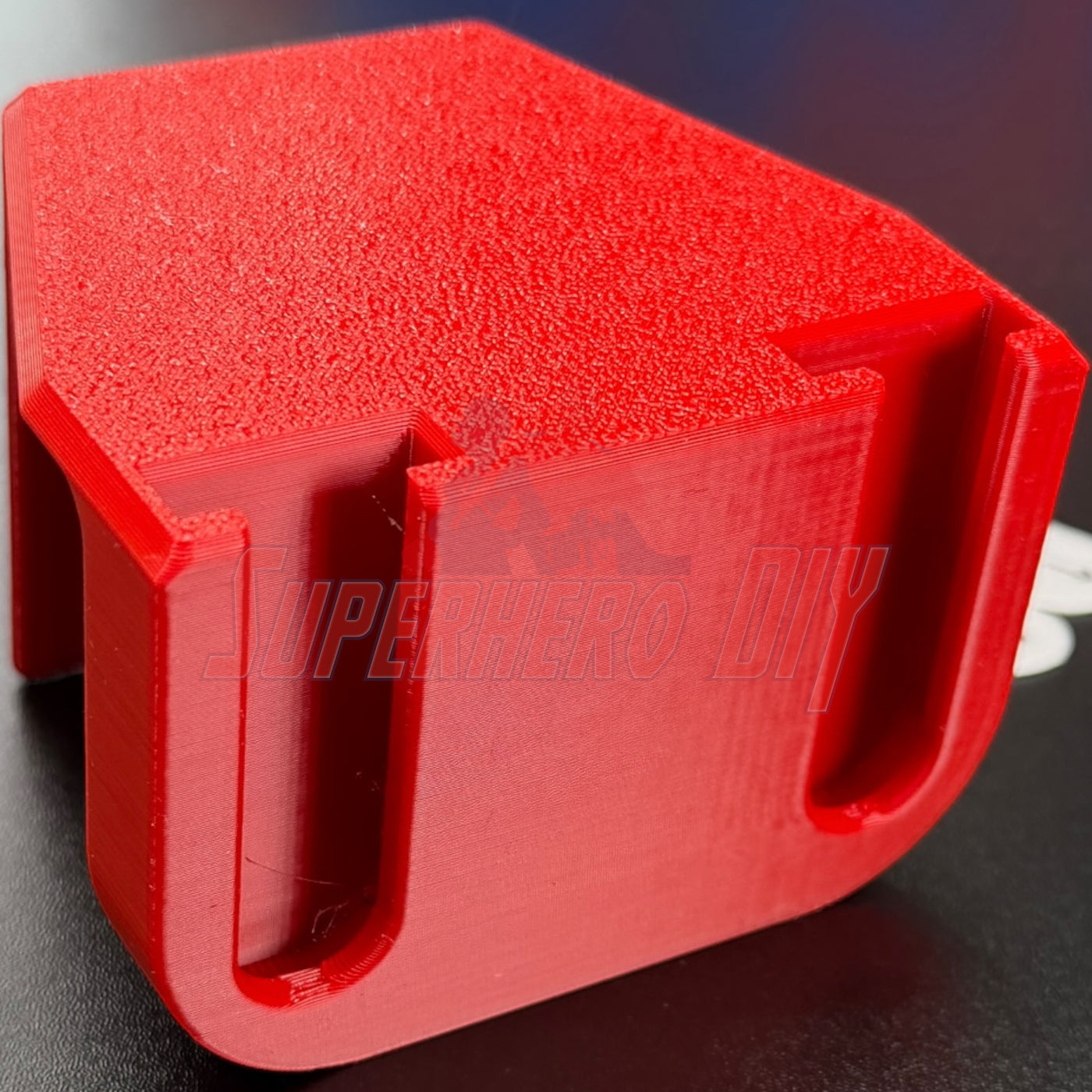 Under-desk PS5 controller mount in red, designed for stylish storage and easy access, no drilling required.