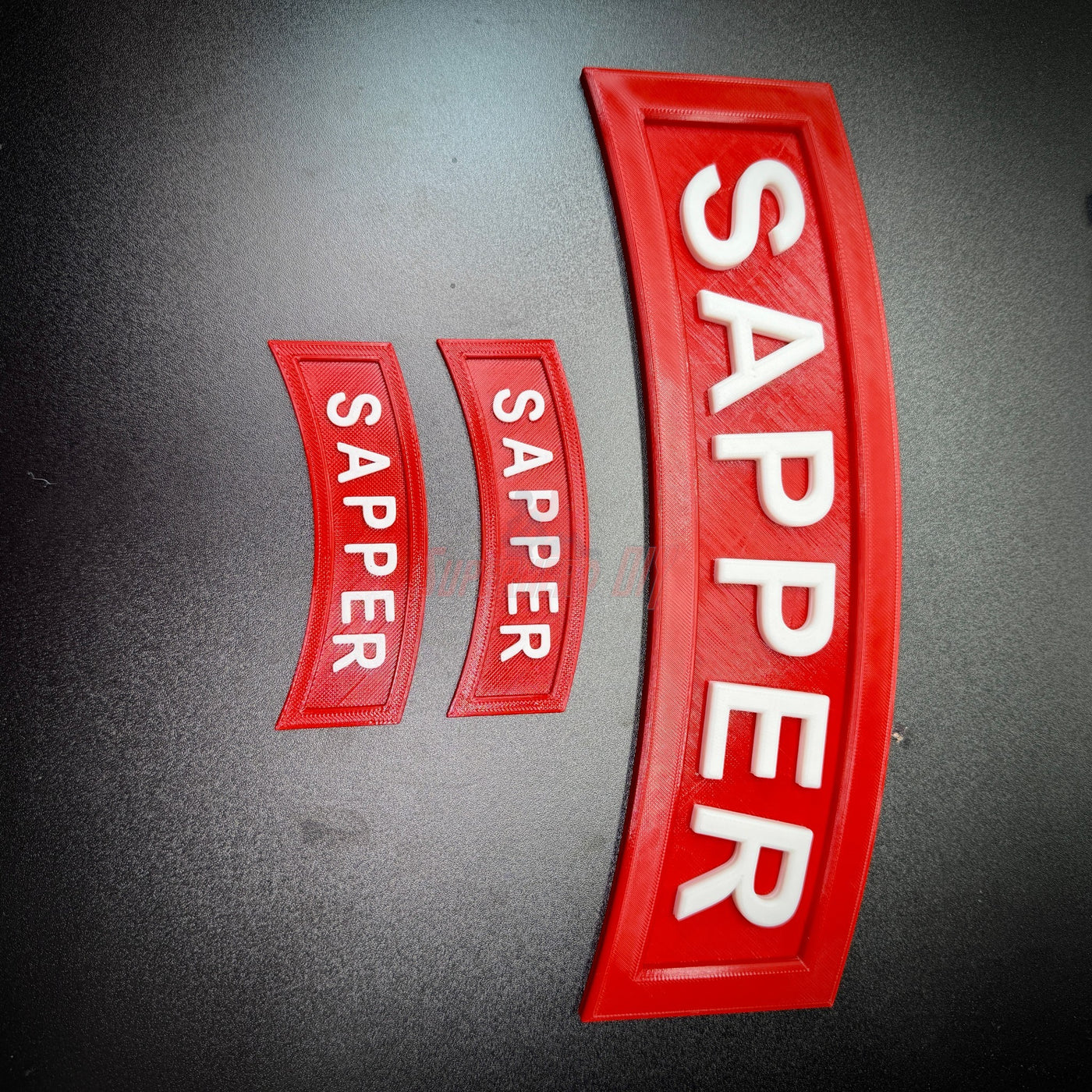 3D Sapper Tab display pieces in multiple sizes, showcasing the iconic Sapper design for combat engineers.