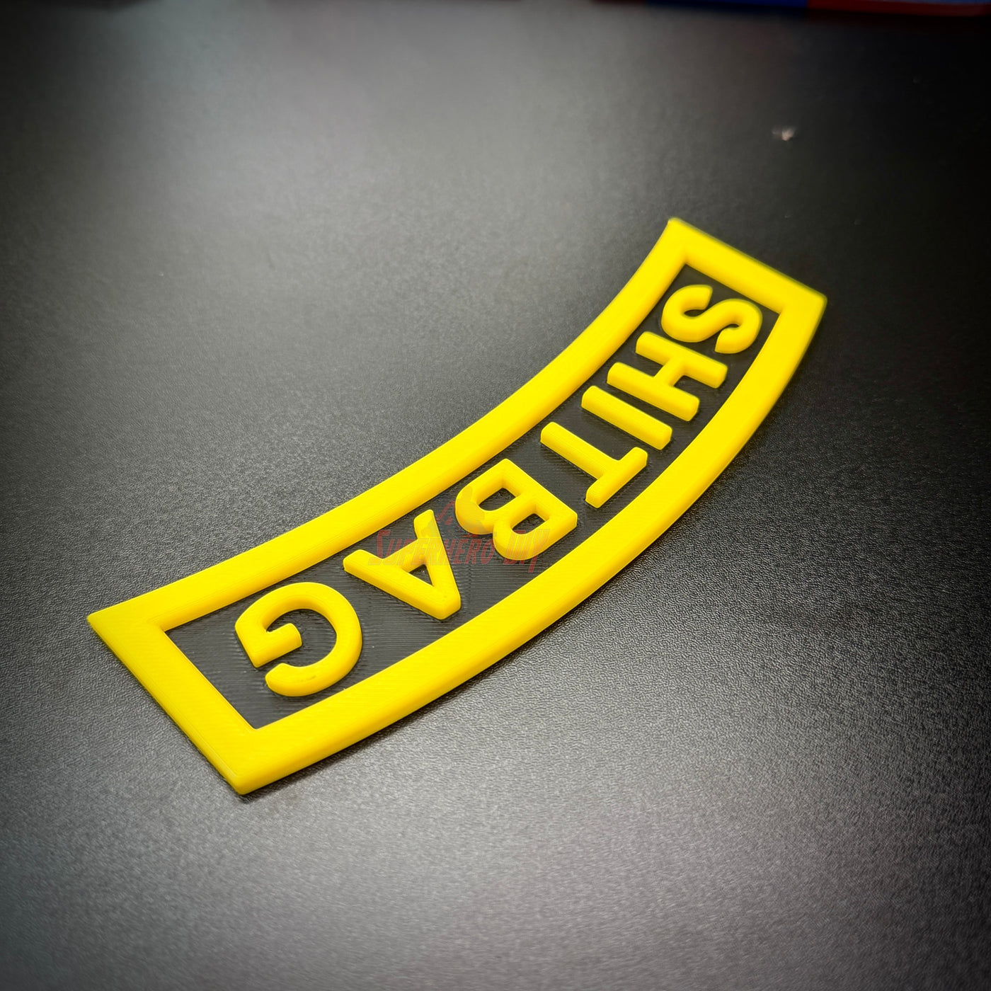 SHITBAG tab in vibrant yellow, perfect gag gift for soldiers and battle buddies.