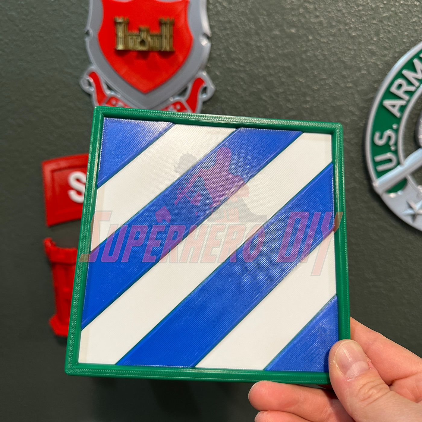 3rd Infantry Division display insignia, 3D-printed blue and white patch for military service recognition, in hand.