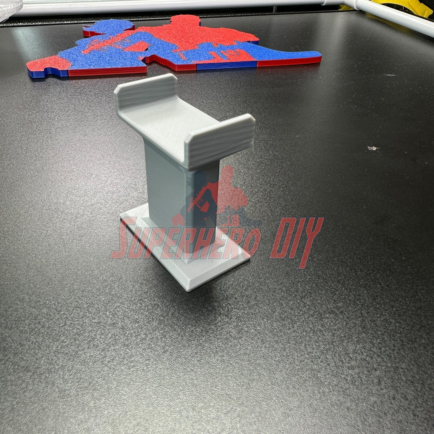 3D-printed toy train track support riser column compatible with BRIO, Imaginarium, and Thomas wooden tracks on display.