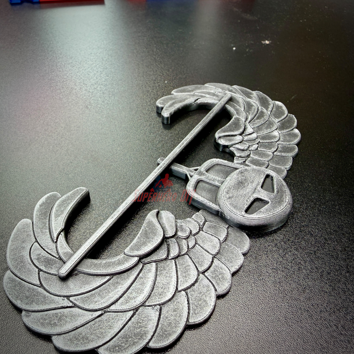 subdued air assault badge display insignia with wings in gray finish on black surface
