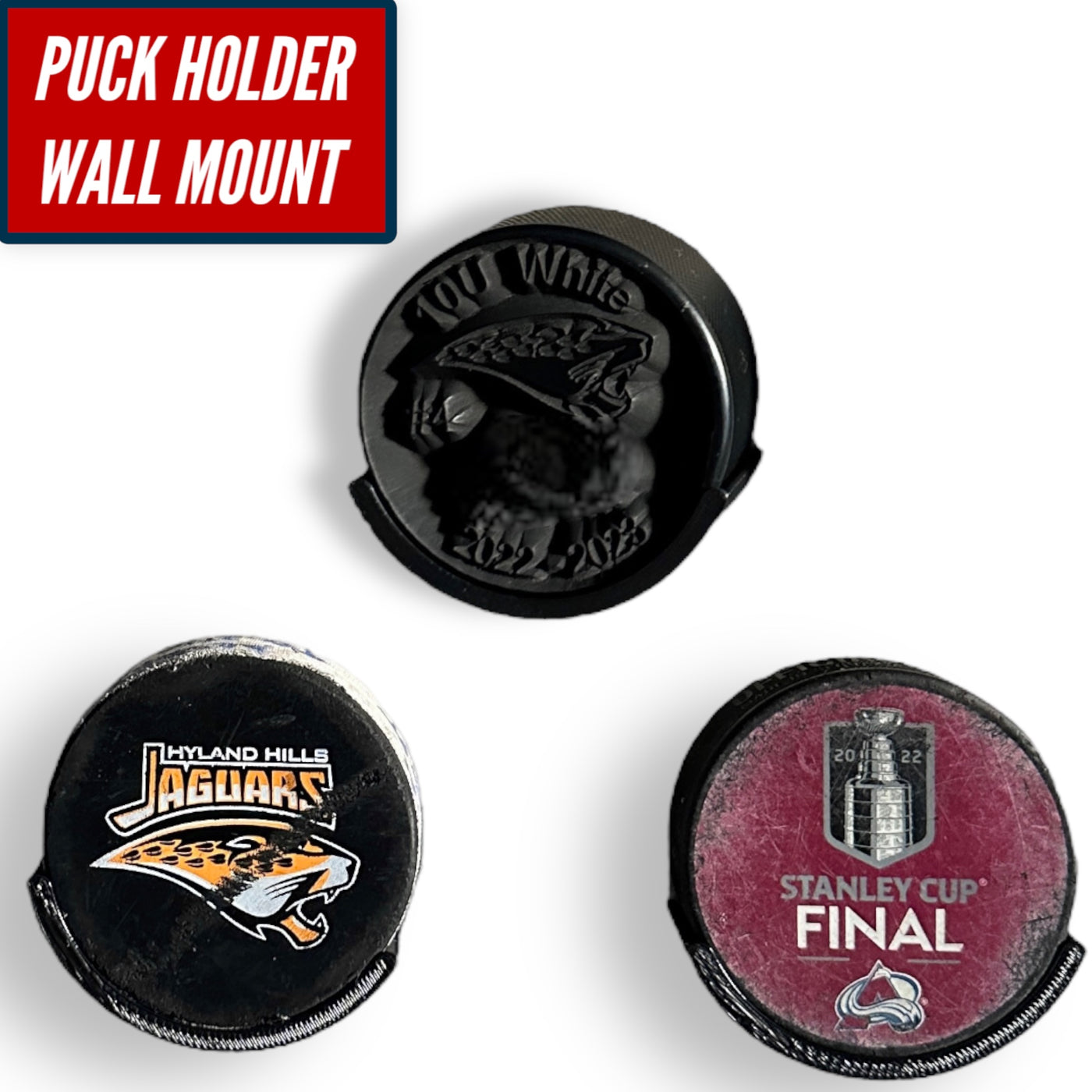Three hockey pucks displayed on a wall mount, showcasing different designs with a puck holder wall mount design.