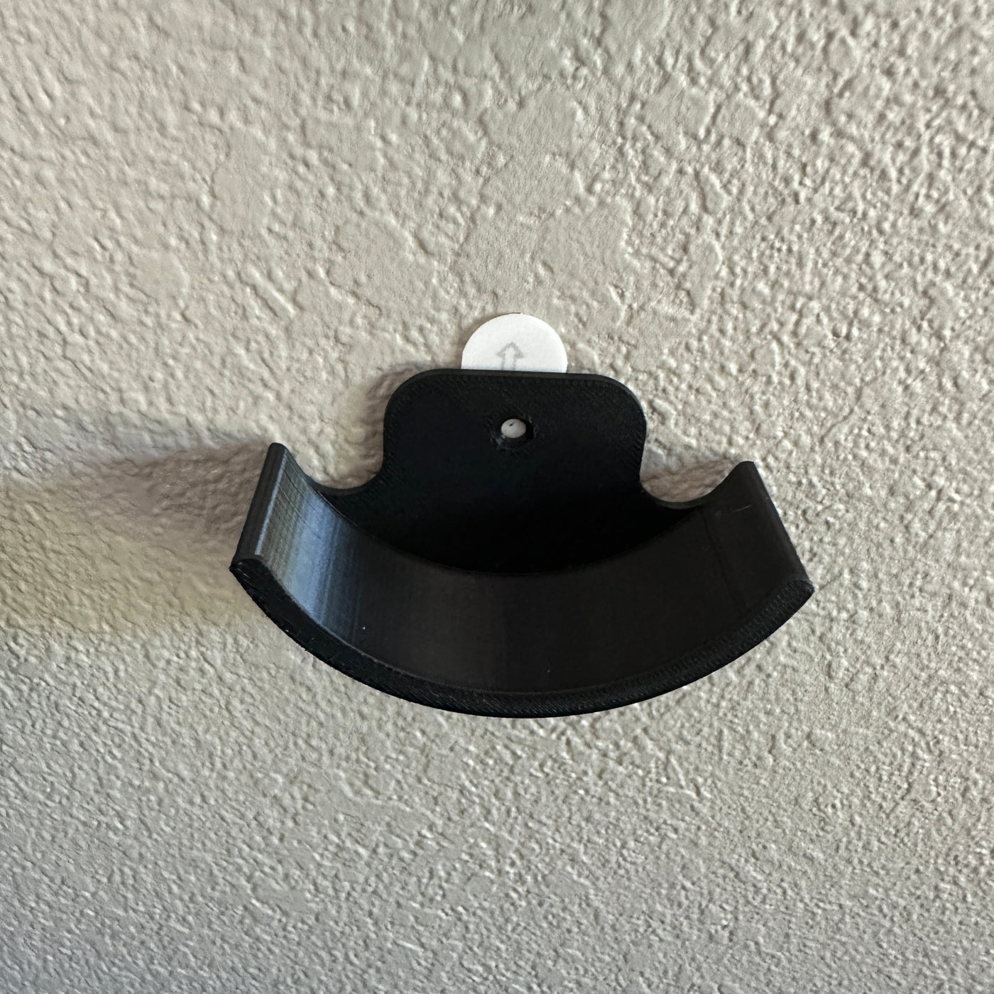 Hockey puck holder wall mount showcasing a sleek black design for displaying hockey pucks.