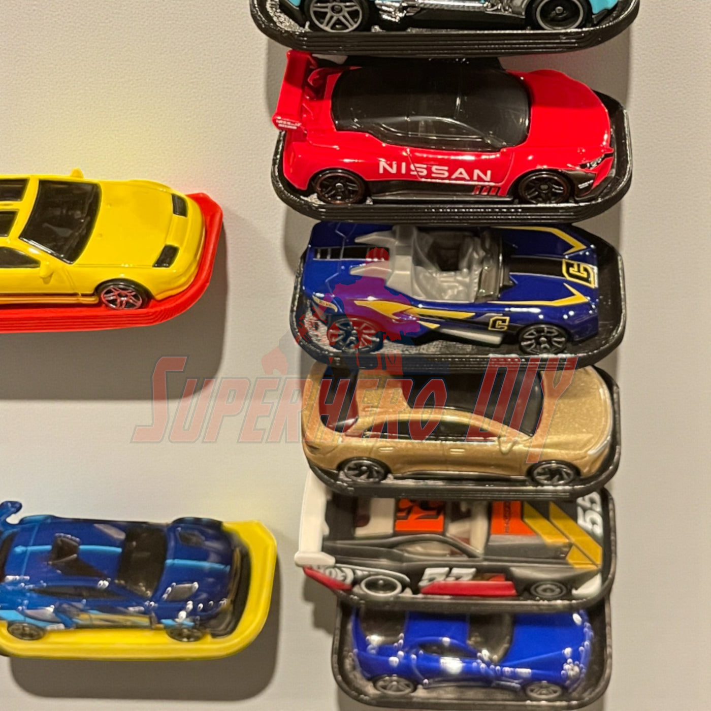 Display shelf for Hot Wheels showcasing 1:64 diecast cars with Command strip included.