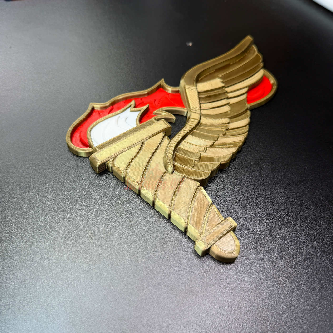 Army Pathfinder Badge displayed with winged torch design, showcasing red and gold finishes.