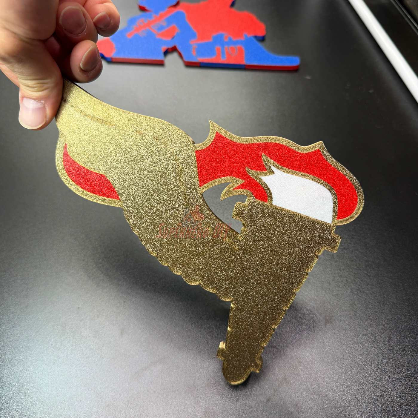 Army Pathfinder Badge display insignia with winged torch design, showcasing gold and red colors.
