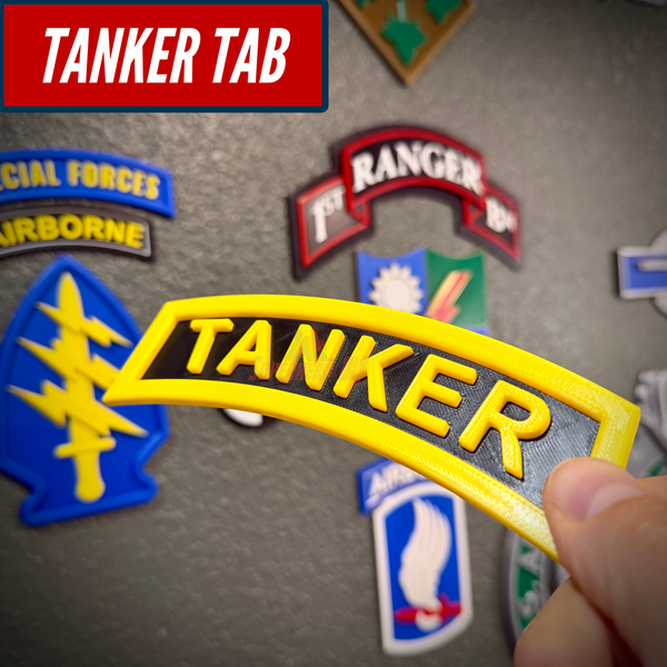 3D tanker tab displayed among various military patches, showcasing its raised lettering and vibrant colors.