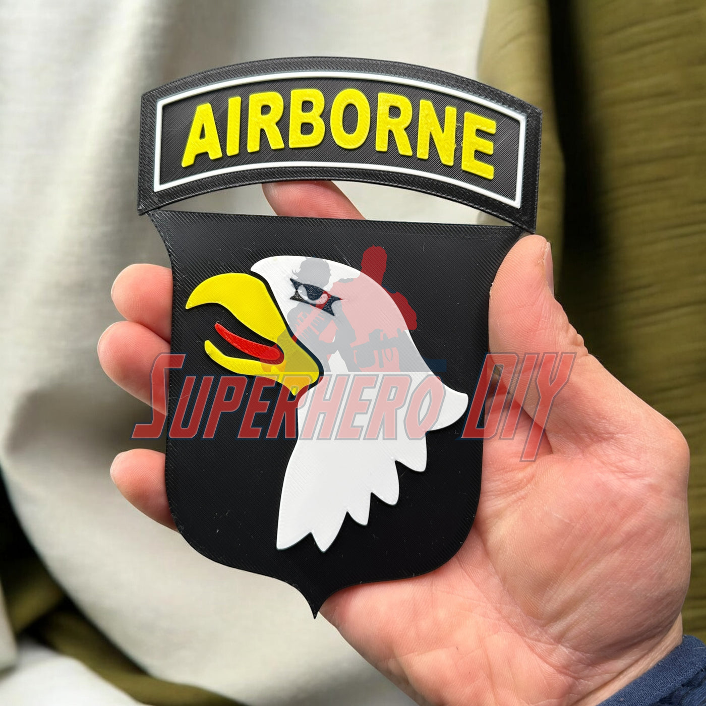 101st Airborne Division display insignia held in hand, showcasing detailed eagle design, ideal for veterans and military memorabilia enthusiasts.