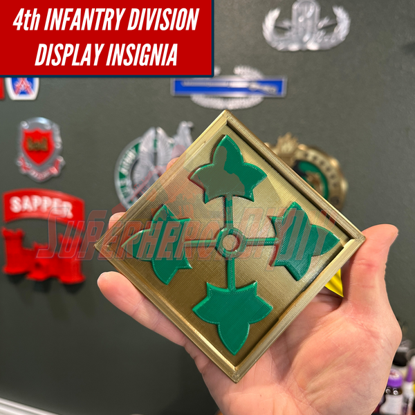4th Infantry Division display insignia 3D-printed in hand, surrounded by military patches in home or office setup.