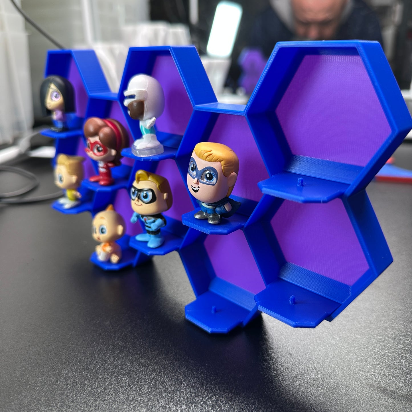 10-Cell honeycomb display for Disney Doorables with mini figures, mounted design showing hexagonal cell structure for collection organization.