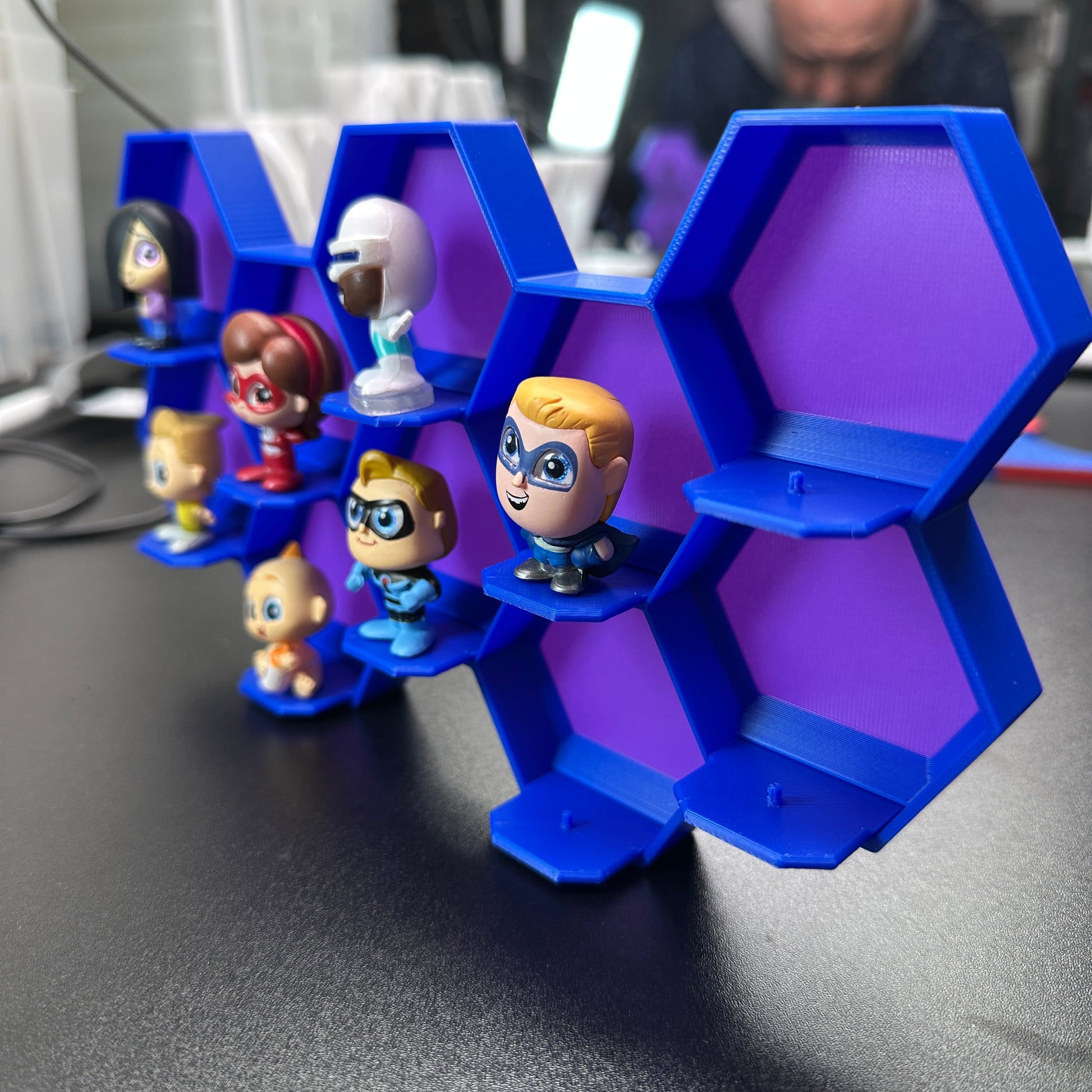 10-Cell honeycomb display for Disney Doorables with mini figures, mounted design showing hexagonal cell structure for collection organization.