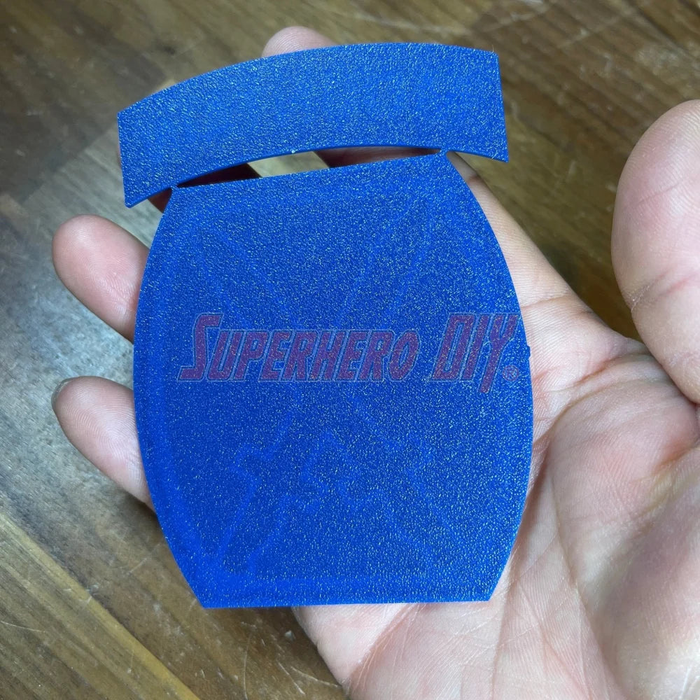 3D-printed 10th Mountain Division insignia in blue held in hand, showcasing clean design and bold lettering.