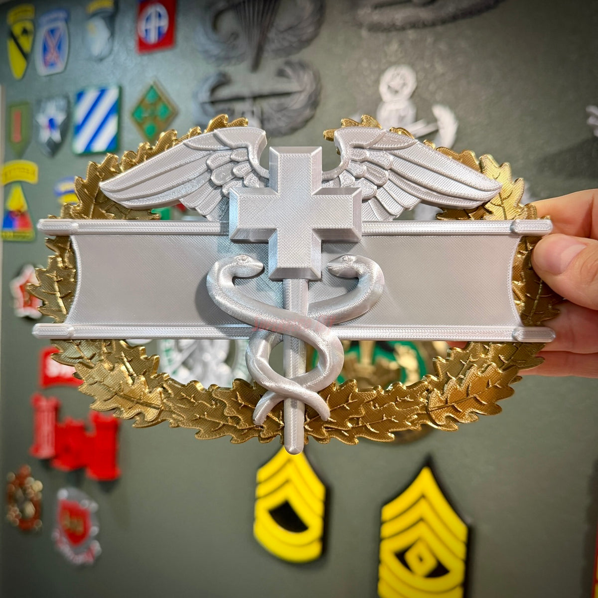 Army medical badge display insignia featuring caduceus and wreath, highlighting EFMB, CMB, MCMB options.