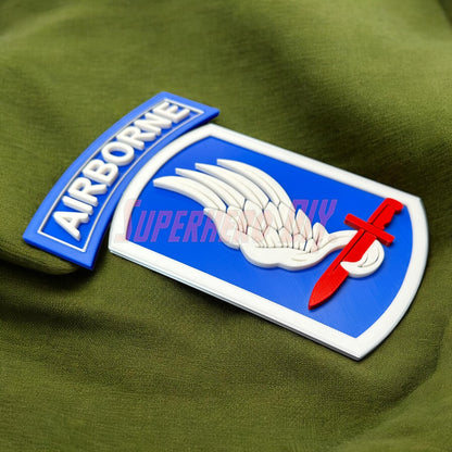 173rd Airborne Brigade display insignia featuring wings and sword design on a green fabric background.