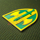 3D 18th Military Police Brigade Display Insignia in green and yellow colors on textured surface