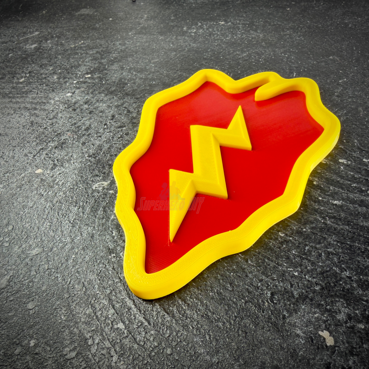Red taro leaf with yellow lightning bolt, 25th Infantry Division display insignia at an angle on dark stone