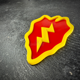 Red taro leaf with yellow lightning bolt, 25th Infantry Division display insignia at an angle on dark stone