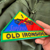 1st Armored Division display insignia in hand, featuring Old Ironsides design and vibrant colors.