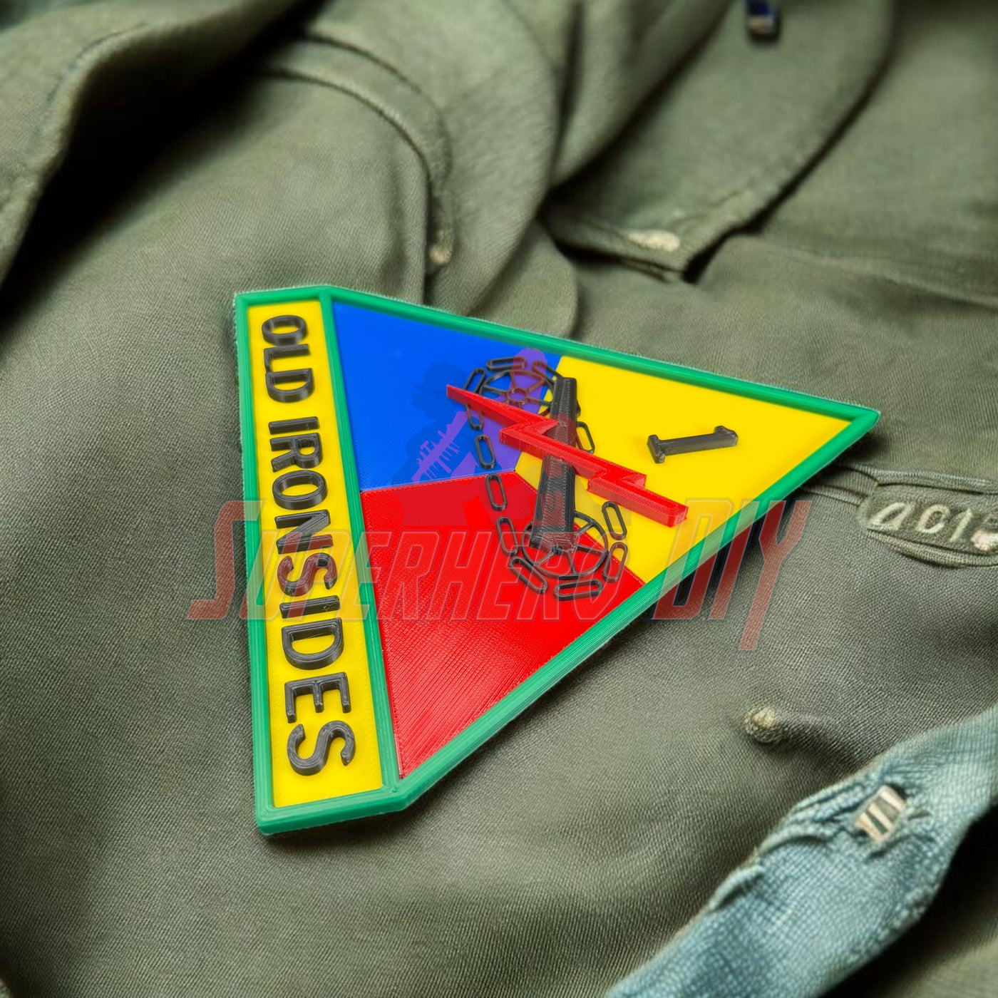1st Armored Division display insignia featuring Old Ironsides emblem on military uniform.