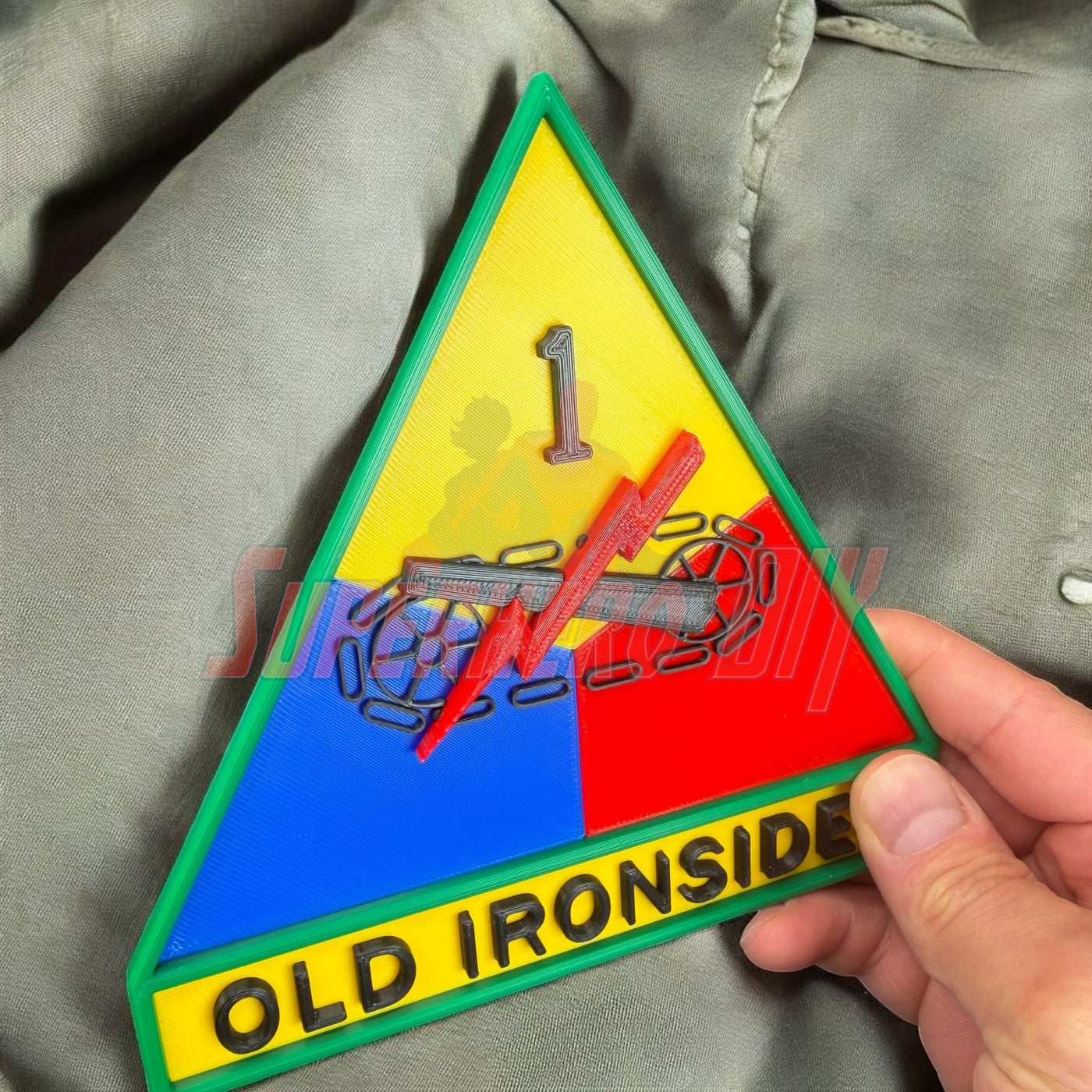 1st Armored Division display insignia featuring OLD IRONSIDES on a background of colored sections.