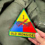 1st Armored Division display insignia featuring the Old Ironsides emblem on a military jacket.