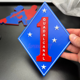 1st Marine Division display insignia featuring Guadalcanal, blue diamond with red numeral one and white stars.