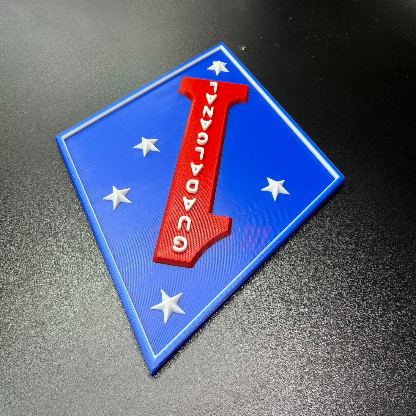 1st Marine Division display insignia featuring blue diamond, red numeral one, and Southern Cross stars.