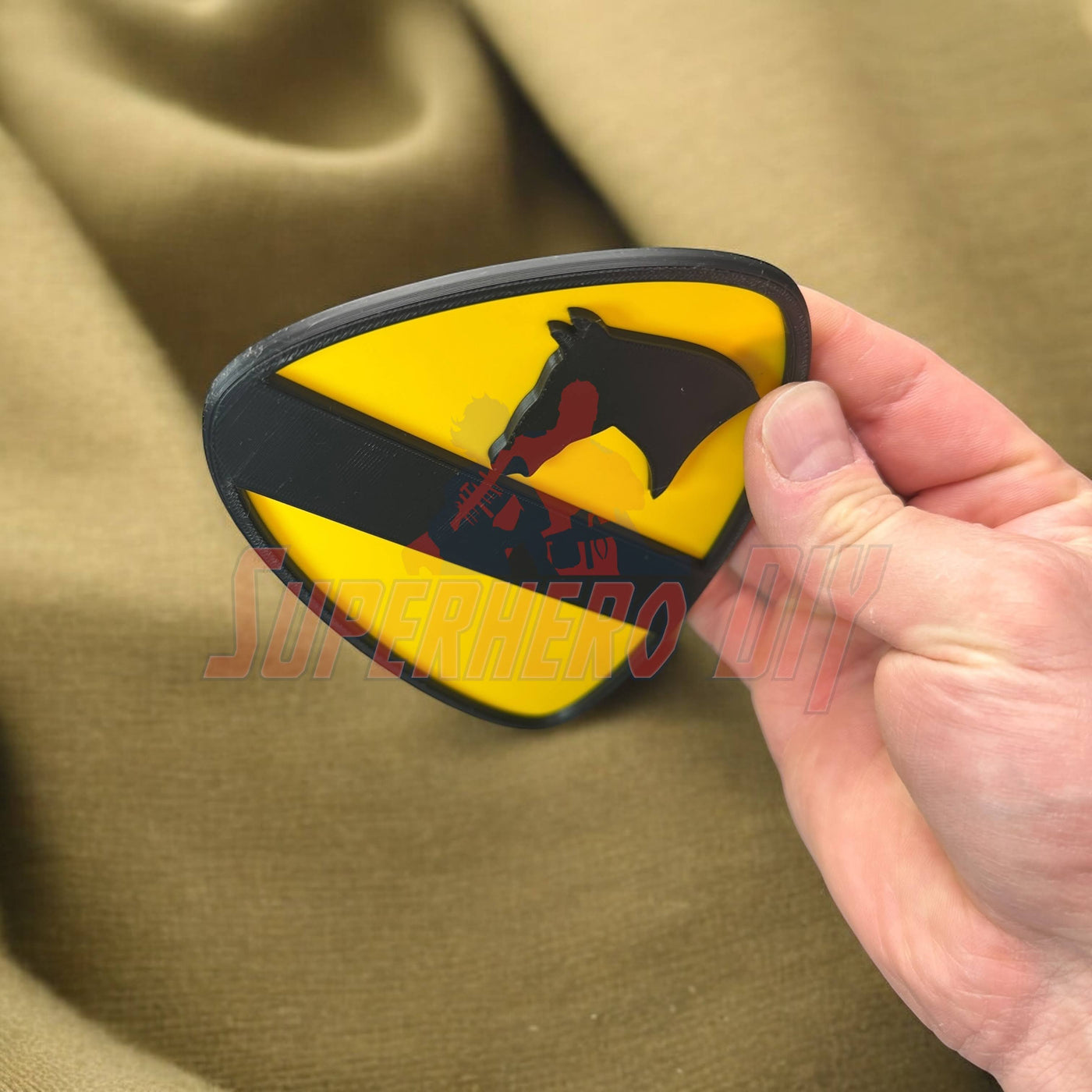 1st Cavalry Division Display Insignia in hand on a fabric background. Military decor for shop, office, or game room.