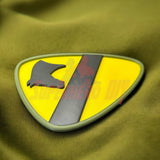 1st Cavalry Division Display Insignia on green fabric, perfect military decor piece for shop or game room.