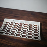 Floating shelf for Funko Pop 2-pack with hex lattice design on a wooden surface.