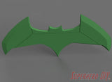 Green bat-shaped model with pointed wings and a central bat symbol cutout against a gray background. - SuperheroDIY