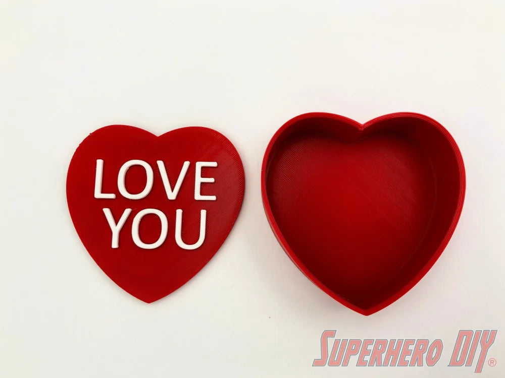 3D-PRINTABLE STL FILE | Candy Heart Gift Box | DIGITAL FILE ONLY - Red candy heart gift box with removable lid featuring white "LOVE YOU" text on top. - SuperheroDIY