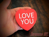3D-PRINTABLE STL FILE | Candy Heart Gift Box | DIGITAL FILE ONLY - Red heart-shaped candy box with white "LOVE YOU" text held in hand on dark wooden surface. - SuperheroDIY