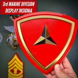 3rd Marine Division display insignia with scarlet shield and gold border, showcasing layered design and symbolic caltrap.