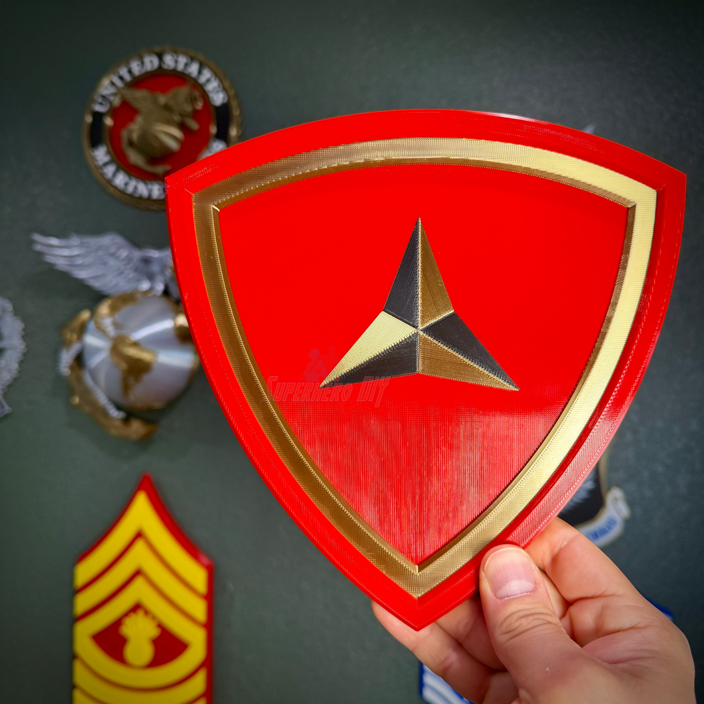 3rd Marine Division display insignia in red and gold, showcasing the Fighting Third emblem.