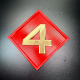 4th Marine Division insignia in relief, featuring a gold numeral 4 on a red diamond background.