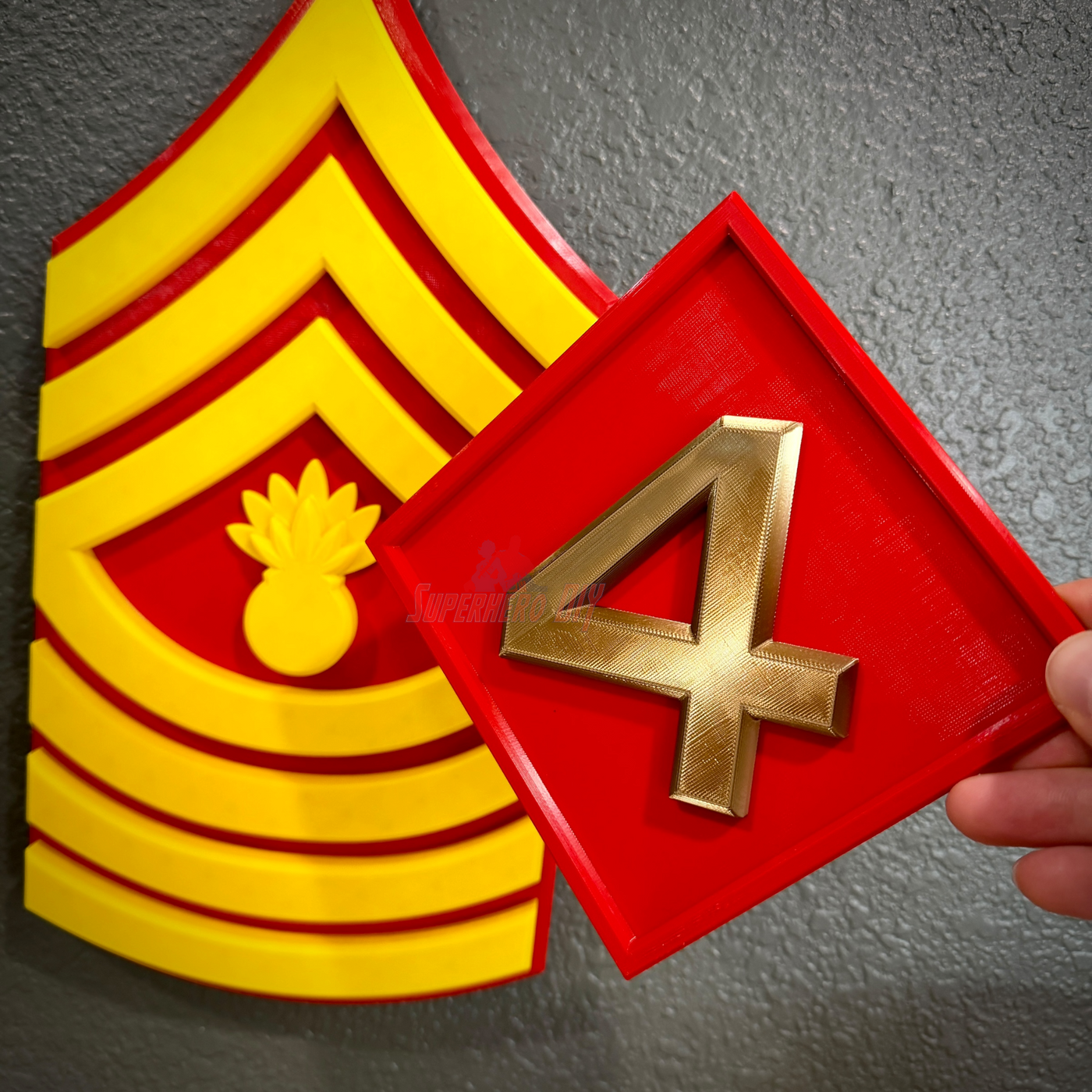 4th Marine Division insignia with a sculpted four in gold and a background featuring the Marine Corps rank insignia.