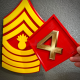 4th Marine Division insignia with a sculpted four in gold and a background featuring the Marine Corps rank insignia.
