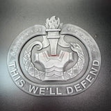 3D US Army emblem featuring a torch and snake with the text 'THIS WE'LL DEFEND' for patriotic displays.