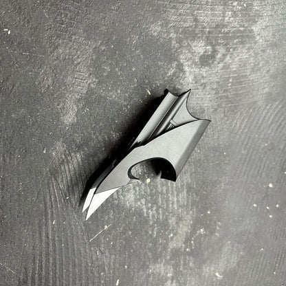 NECA BATMAN 1989 Folding Magnetic Batarang (LOOSE) displayed on a dark surface, showcasing its detailed design.