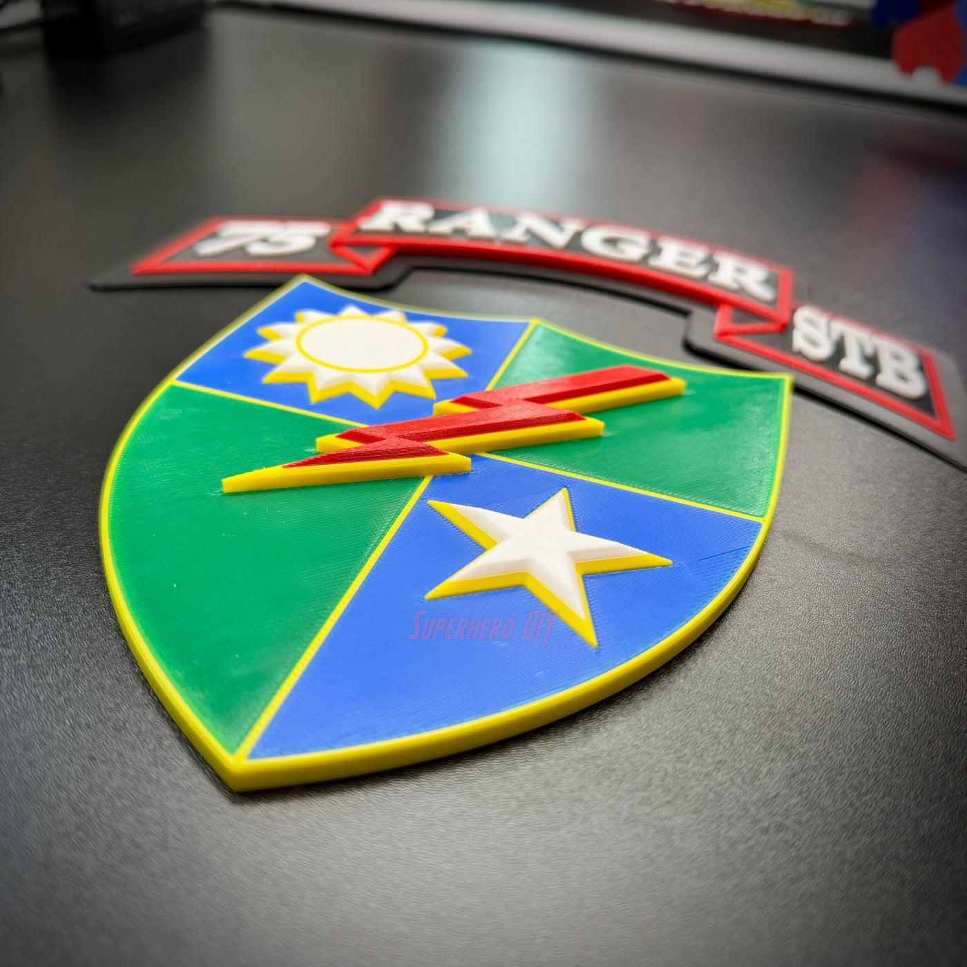75th Ranger Regiment display insignia on a black surface featuring a colorful shield and text.