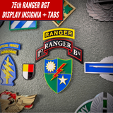75th Ranger Regiment display insignia with tabs on a display wall, showcasing military insignia and decorations.